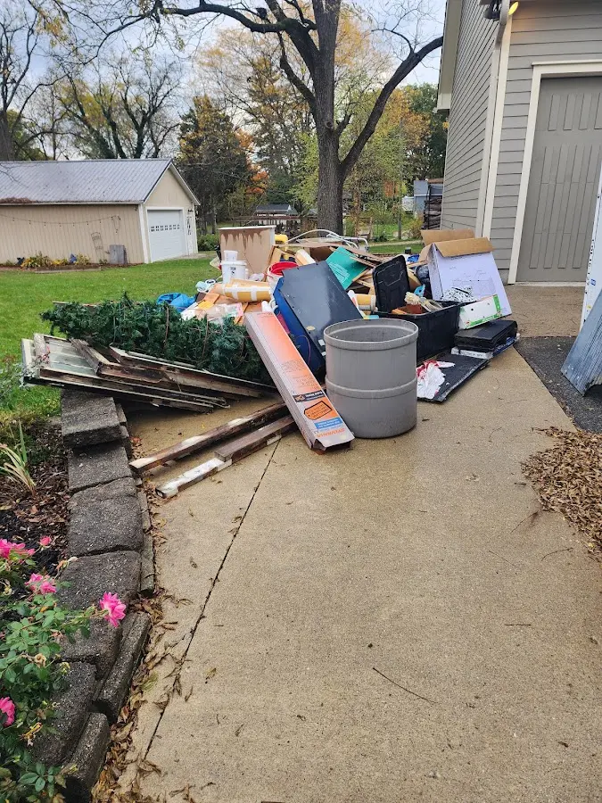 Dumpster being loaded with debris for Roofing Dumpster Rental in Emmetsburg